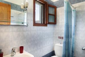 a bathroom with a sink and a toilet and a window at Studios Asterias 3 in Astypalaia +20 photos