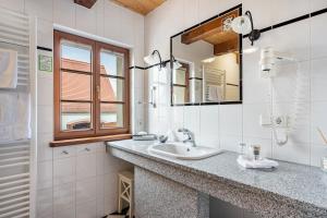 a bathroom with a sink and a mirror at Weingut Schuh in Coswig +146 photos