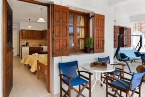 a kitchen and living room with a table and chairs at Studios Asterias 3 in Astypalaia