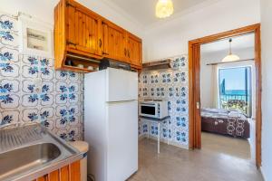 a kitchen with a refrigerator and a microwave at Mires House Front Studio 2 in Agios Gordios