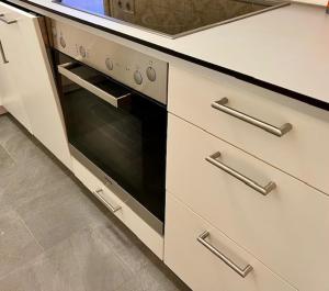 a kitchen with a stove and a sink at Fewo Tannenduft - Freudenstadt in Freudenstadt