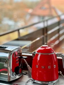 a red toaster sitting on top of a table at Fewo Tannenduft - Freudenstadt in Freudenstadt +17 photos