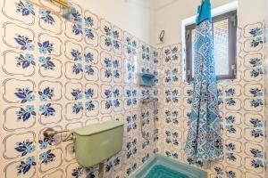 a bathroom with blue and white tiles on the wall at Mires House Front Studio 2 in Agios Gordios +19 photos