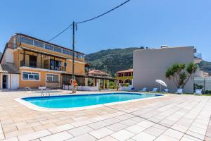 a swimming pool in front of a building at Mires House Front Studio 2 in Agios Gordios