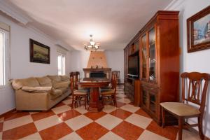 a living room with a couch and a table and chairs at Villa Minerva in Ronda