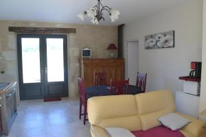 a living room with a yellow couch and a table at Ferme De Berteillé in Castérat-Bouzet