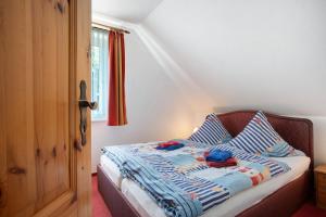 a bedroom with a bed with two slippers on it at Fewo 11 - Halbinsel Darss - Ostsee in Wieck