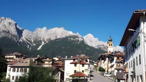 a view of a town with mountains in the background at Casa D'Ambros - Cadore in Santo Stefano di Cadore