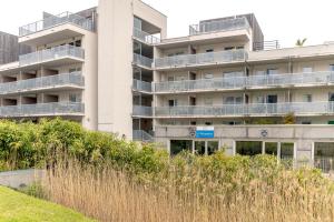 an apartment building with balconies on the side of it at Appartement Aix Les Bains in Aix-les-Bains