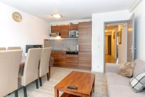 a living room with a table and a kitchen at Appartement Aix Les Bains in Aix-les-Bains +12 photos