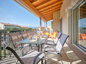 a patio with a table and chairs on a balcony at New Casa Tiberio in Lazise