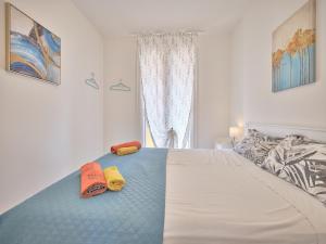 a bedroom with a bed with two slippers on it at New Casa Tiberio in Lazise +27 photos