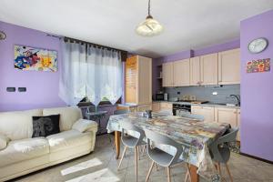 a kitchen and living room with a table and a couch at Casa Michod Chatillon - Nonna Genia in Châtillon