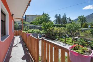 a balcony with potted plants on a wooden fence at Casa Michod Chatillon - Nonna Genia in Châtillon