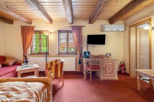 a bedroom with a bed and a desk and a tv at Weingut Schuh in Coswig