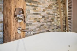 a bathroom with a bath tub and a sink at Ferienwohnung Stod´l in Freyung +14 photos