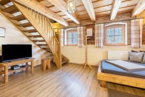 a living room with a bed and a staircase at Ferienwohnung Stod´l in Freyung