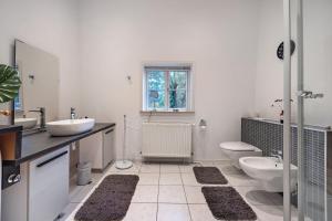 a white bathroom with a sink and a toilet at Ferienwohnung Varga Schafstedt in Schafstedt +22 photos