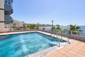 a swimming pool with a view of the water at Brisa Marina in Almuñécar