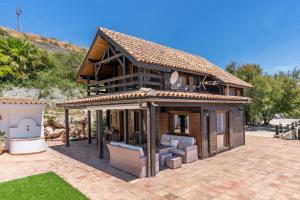 a small house with a porch and a patio at Finca La Haima in Motril