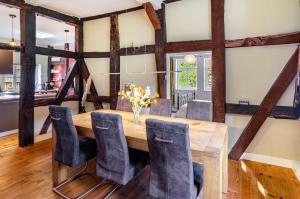 a dining room with a wooden table and chairs at Villa Gottstreu in Gottstreu