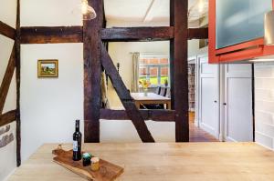 a kitchen with wooden beams and a table with a bottle of wine at Villa Gottstreu in Gottstreu