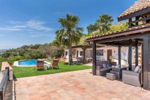 a backyard with a pool and a house at Finca La Haima in Motril