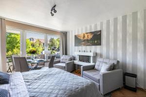 a bedroom with a bed and chairs and a table at Ferienwohnung mit Badestrand in Glücksburg