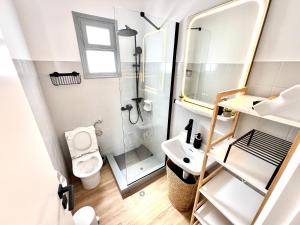 a small bathroom with a toilet and a sink at aeolian blu 5 in Parikia +36 photos