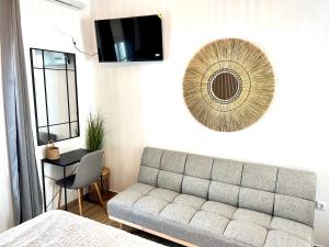 a living room with a couch and a mirror at aeolian blu 5 in Parikia