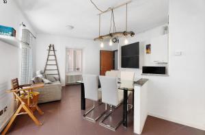 a kitchen and living room with a table and chairs at Vecchia Scala in Germignaga