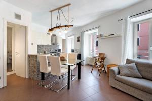 a kitchen and living room with a table and chairs at Vecchia Scala in Germignaga