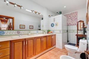 a bathroom with two sinks and a toilet at Rosa del Negro in Alojera +31 photos