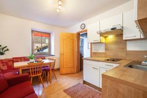 a kitchen and living room with a table and a couch at Ferienwohnung Jonagold Schnalserhof in Laces