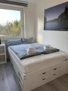 a bed in a bedroom with a large window at Ferienwohnung deluxe in Goslar