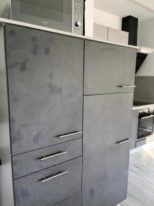 a kitchen with stainless steel cabinets and a microwave at Ferienwohnung deluxe in Goslar