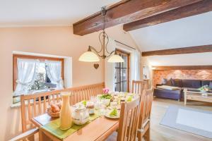 a dining room with a table and a living room at Beim Kreuzfelder Zwiesel in Inzell