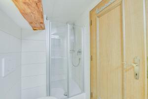 a shower with a glass door in a bathroom at Beim Kreuzfelder Zwiesel in Inzell +28 photos