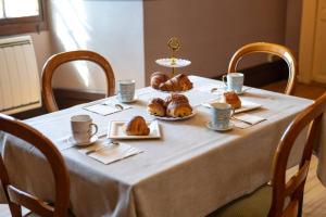 a table with croissants and pastries on it at Château De La Rive in Cruet +34 photos