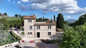 an aerial view of a stone house with trees at Umbriance Villa con piscina privata in Stroncone