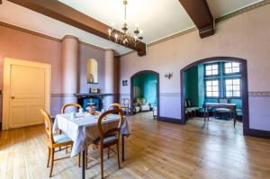 a dining room with a table and chairs at Château De La Rive in Cruet