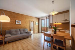 a living room with a couch and a table at Langstein Wohnung Lavendel in Coldrano