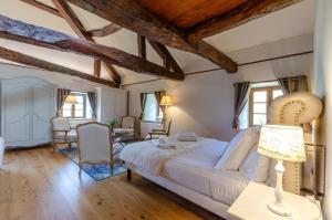 a bedroom with a large bed in a room with wooden ceilings at Château De La Rive in Cruet