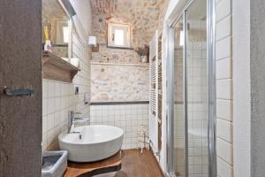 a bathroom with a white sink and a shower at Antico Frantoio in Ceriale +37 photos