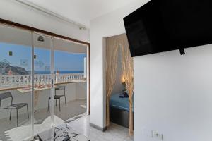 a room with a balcony with a view of the ocean at vv Luca vista mar in Puerto Rico de Gran Canaria