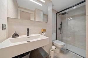 a bathroom with a sink and a toilet and a shower at Kaixo in Calafell +11 photos