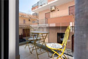 a balcony with two chairs and a table on a balcony at I Tramonti Del Golfo - Kennedy in Balestrate
