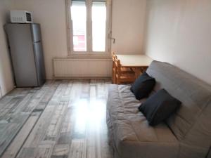 a living room with a couch and a table at Chez Chriss in Bourges