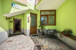 a patio with a table and chairs in a building at Agritur piazera con terrazzo in Ronzo Chienis