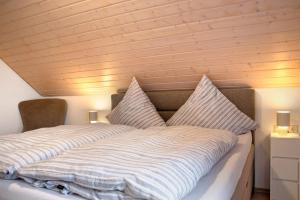 a bedroom with a bed with two pillows on it at Wohnung Karin in Spalt